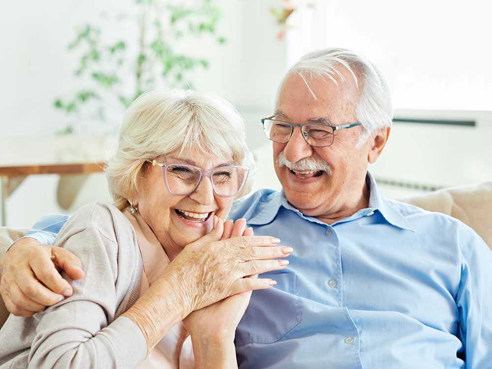 Senior couple sitting together on a sofa